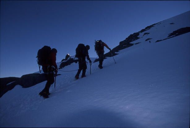 Hikers climbing on a mountain at dawn