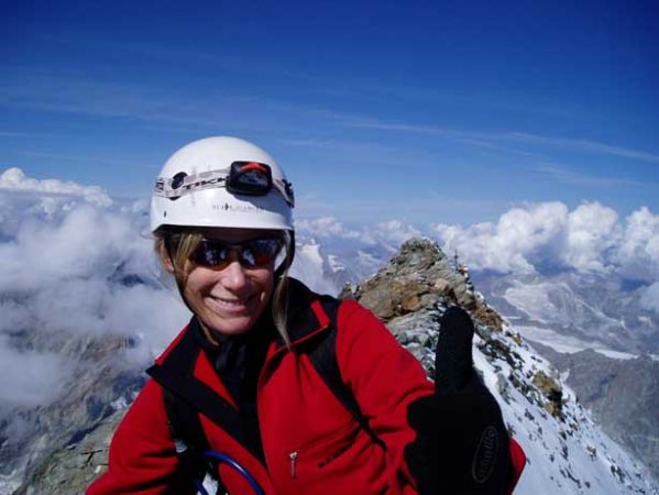 Woman in red on top of the mountain